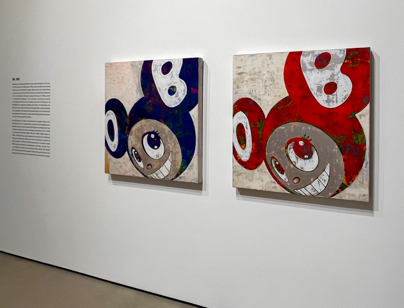 Art pieces of the same smiling character, the left is blue and the right is red.